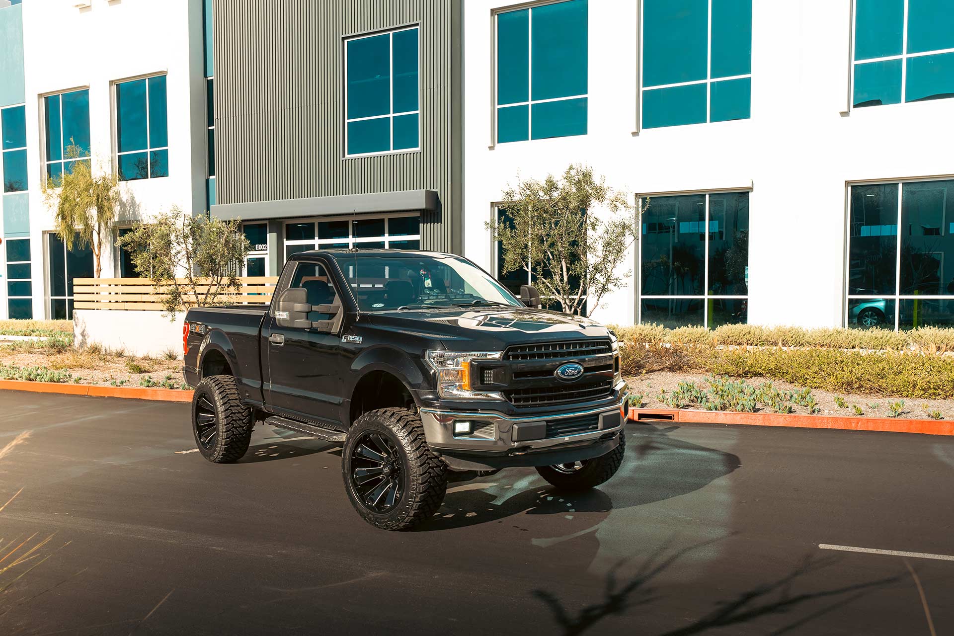 black ford f-150 with gloss black milled h506 off road wheels