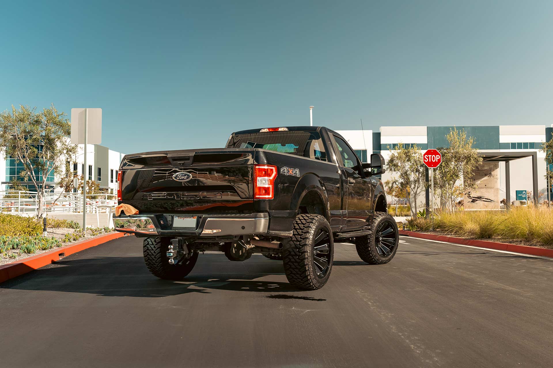 black ford f-150 with gloss black milled h506 off road wheels