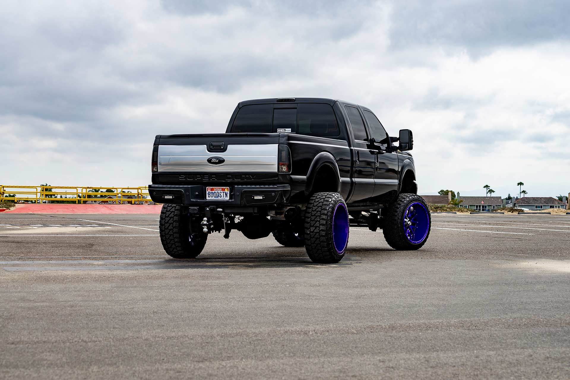 black ford f-250 with custom purple finish hardrock h700 truck wheels