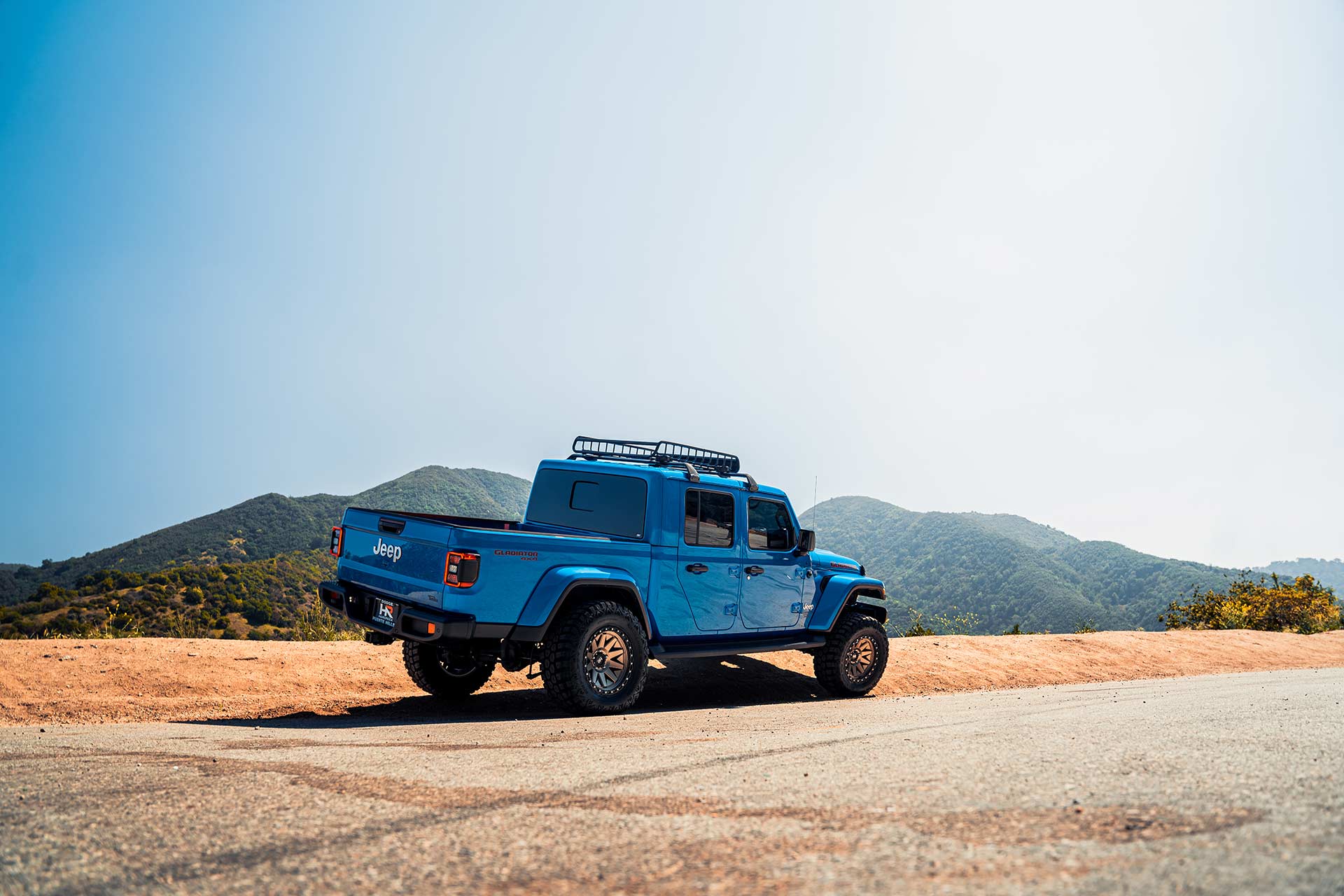 blue jeep gladiator jt with matte bronze hardrock h106 off road wheels