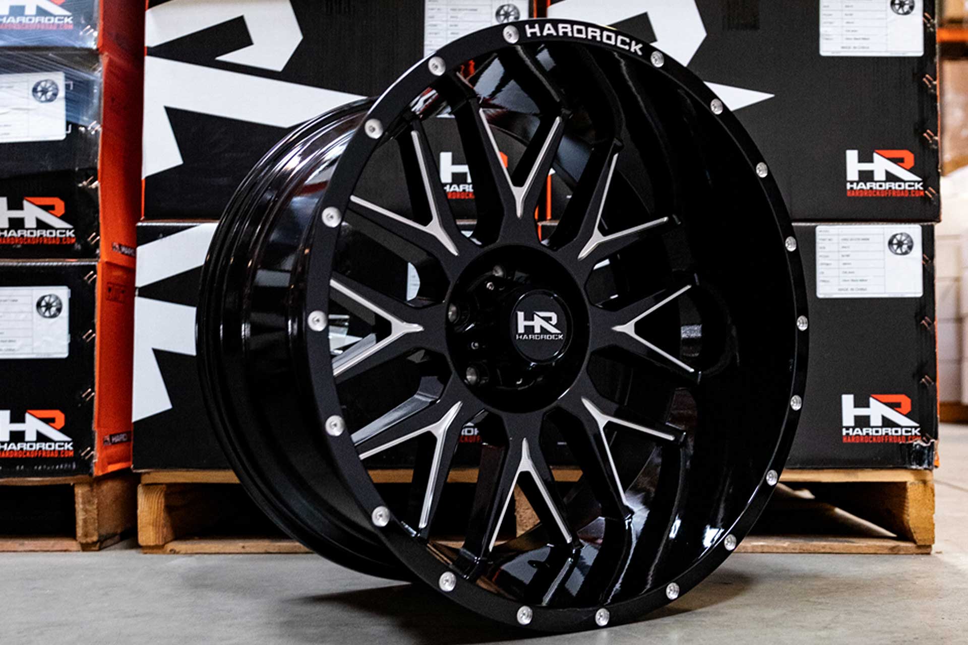 gloss black machined hardrock offroad h500 in warehouse next to hardrock offroad wheel boxes