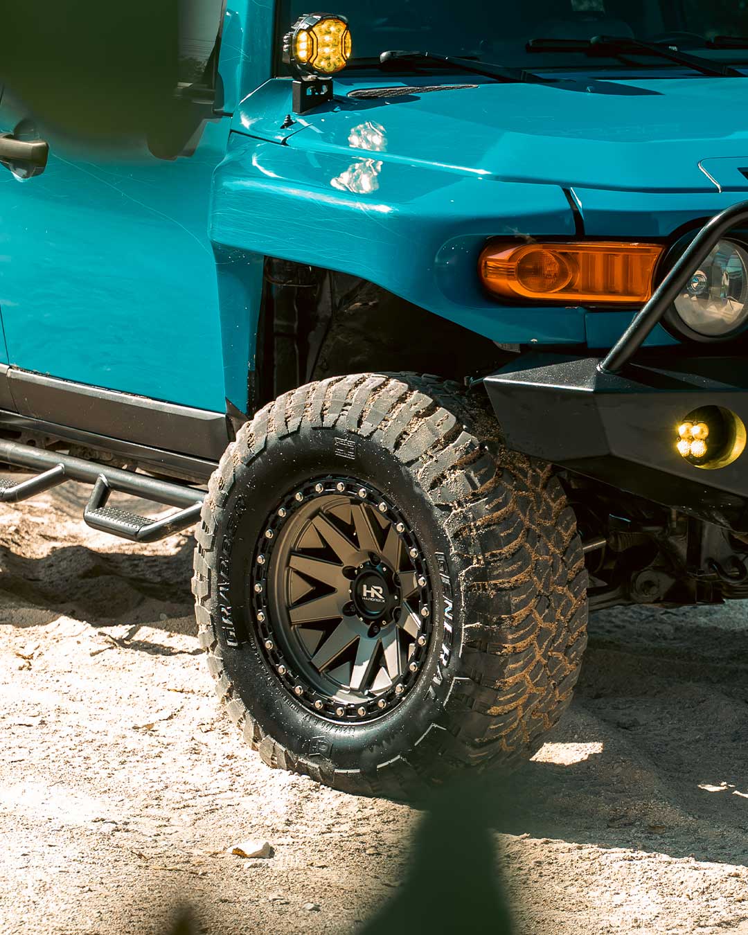 blue fj cruiser with matte bronze hardrock offroad h106 wheels and proper bolt pattern