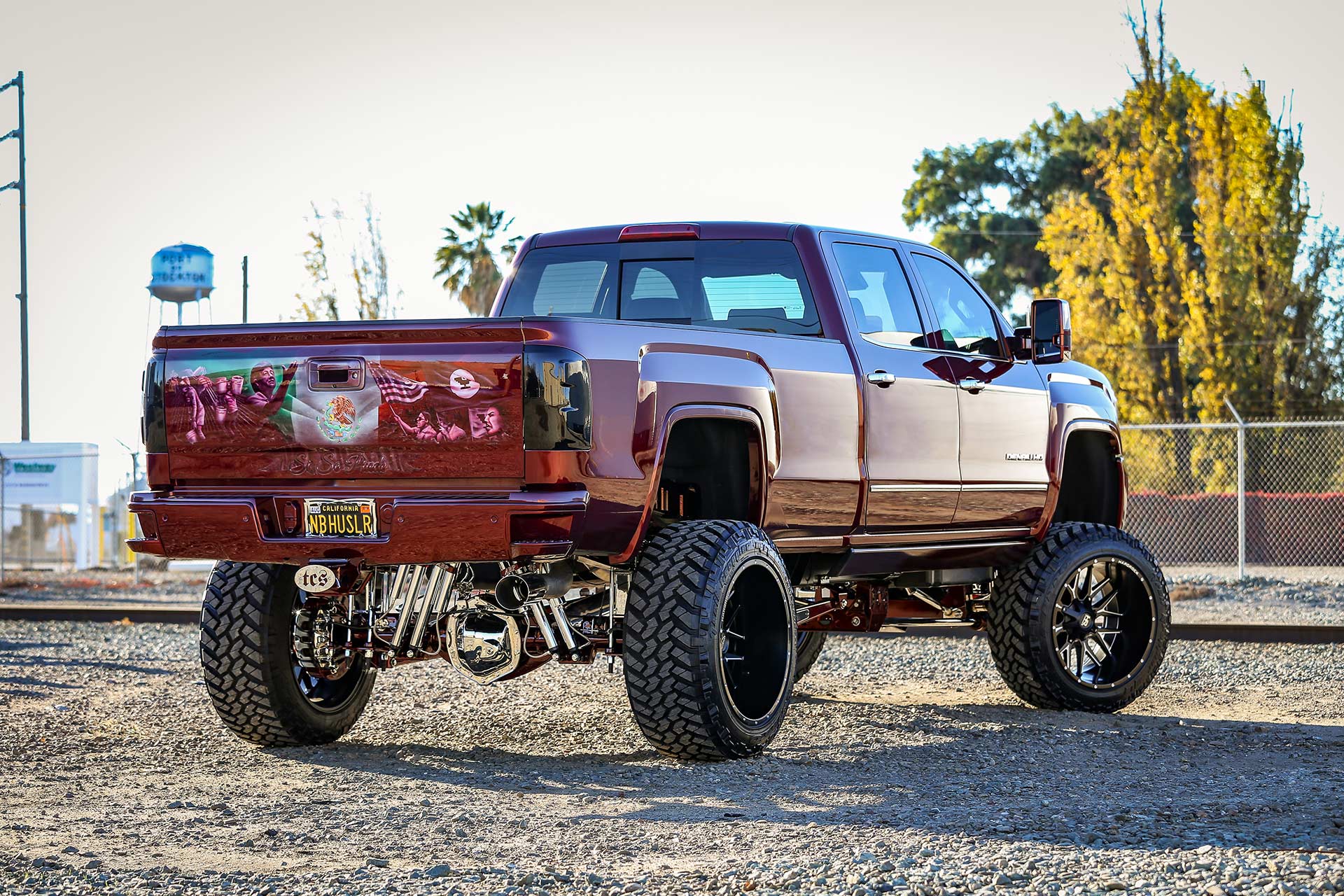 red gmc sierra 3500 with gloss black milled hardrock h700 truck wheels