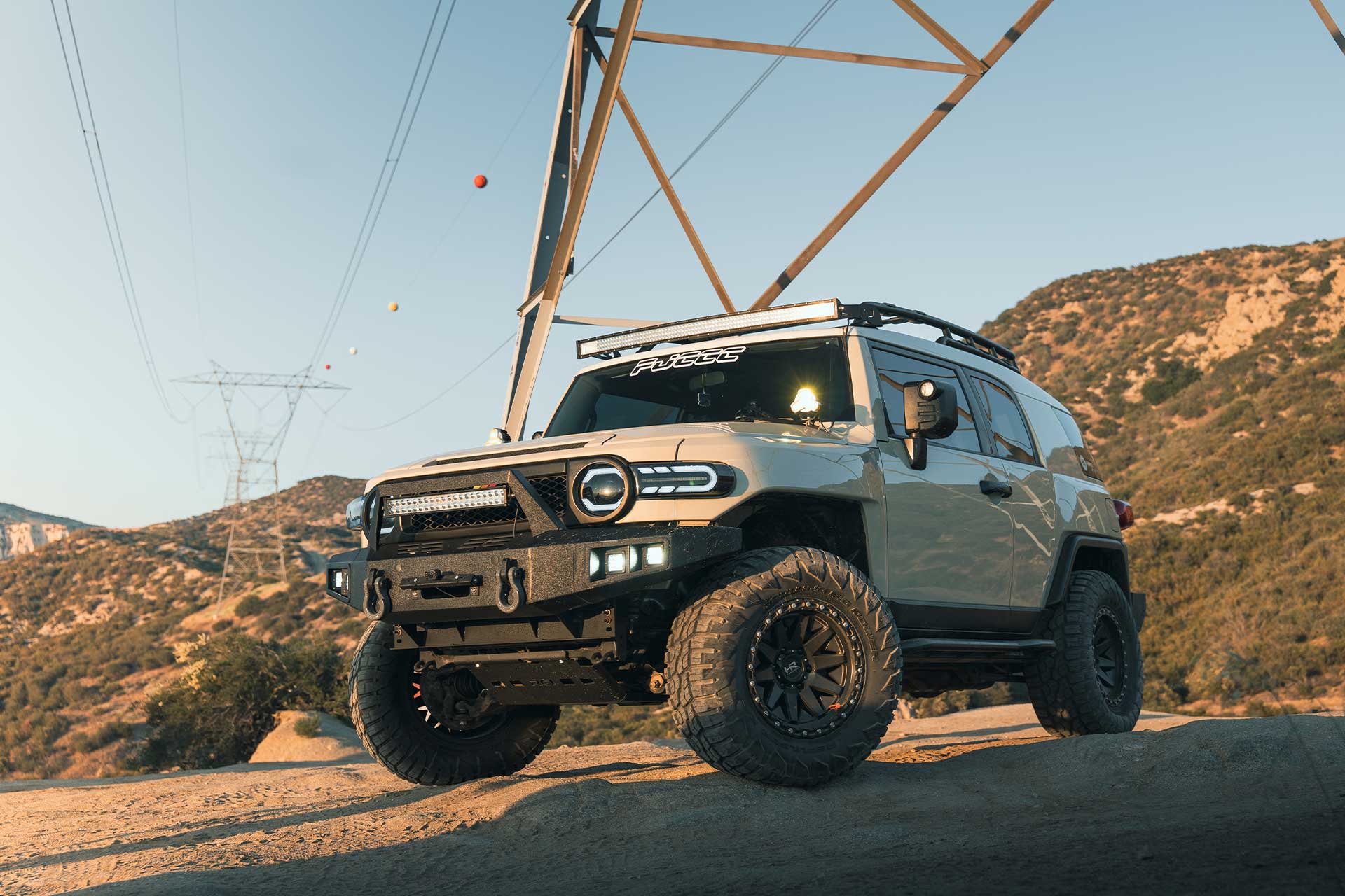 sandstorm toyota fj cruiser with matte black h106 off road wheels on off road trail