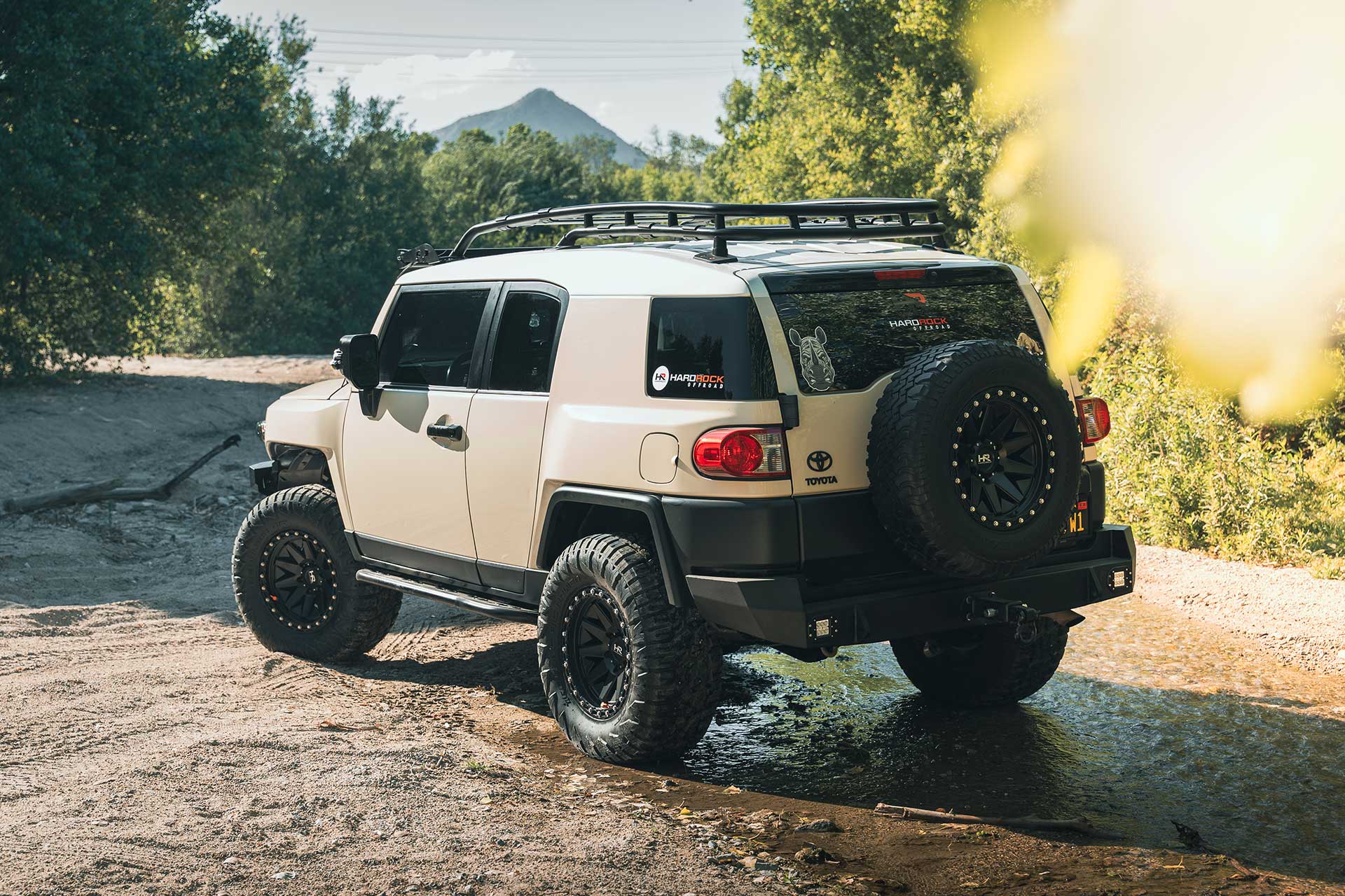 sandstorm toyota fj cruiser with matte black h106 off road wheels on off road trail