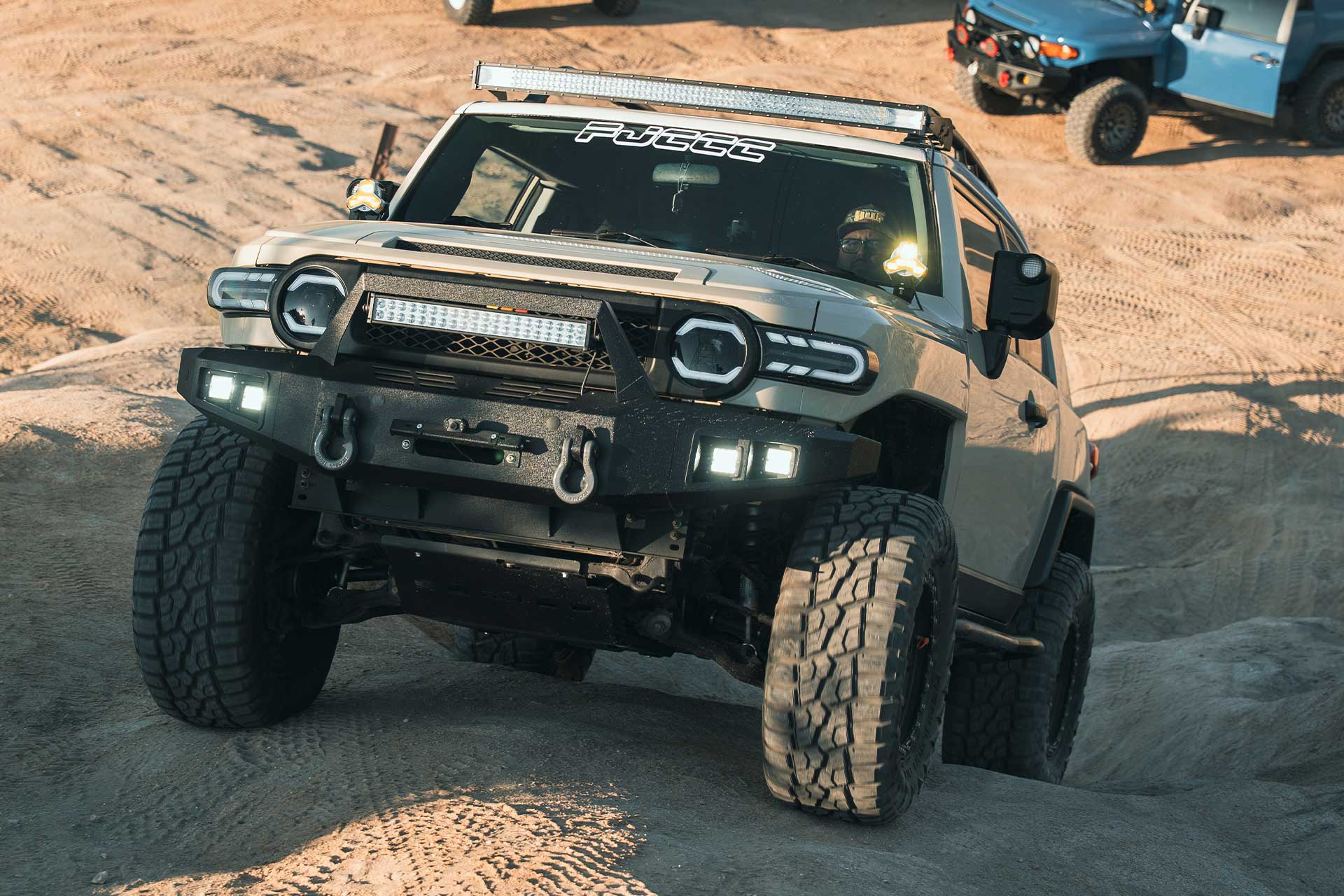 sandstorm toyota fj cruiser with matte black h106 off road wheels on off road trail