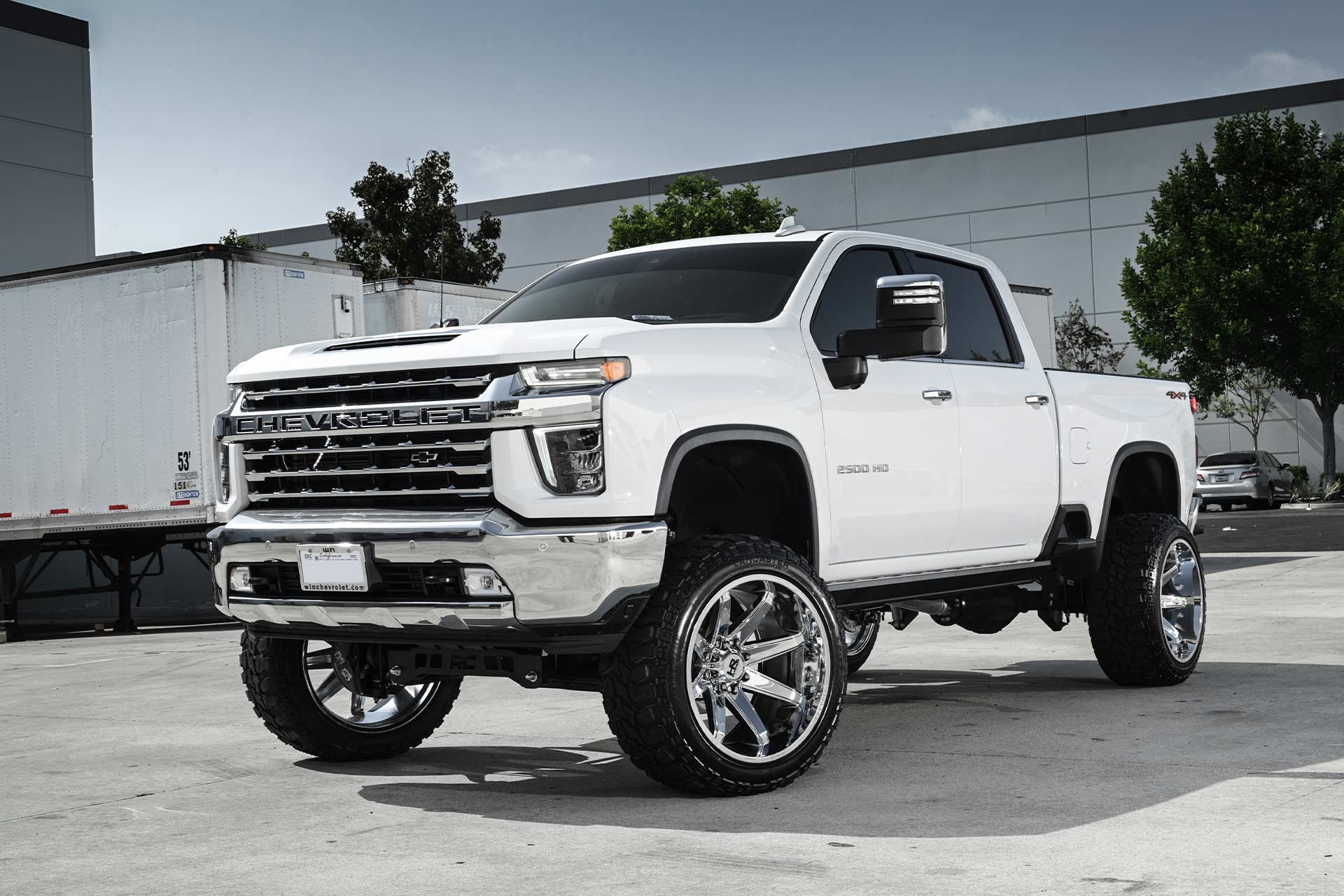 white chevy silverado 2500 with gloss black milled hardrock h502 off road wheels