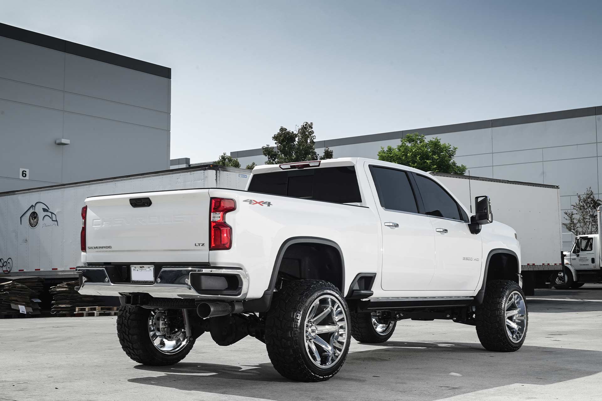 white chevy silverado 2500 with gloss black milled hardrock h502 off road wheels