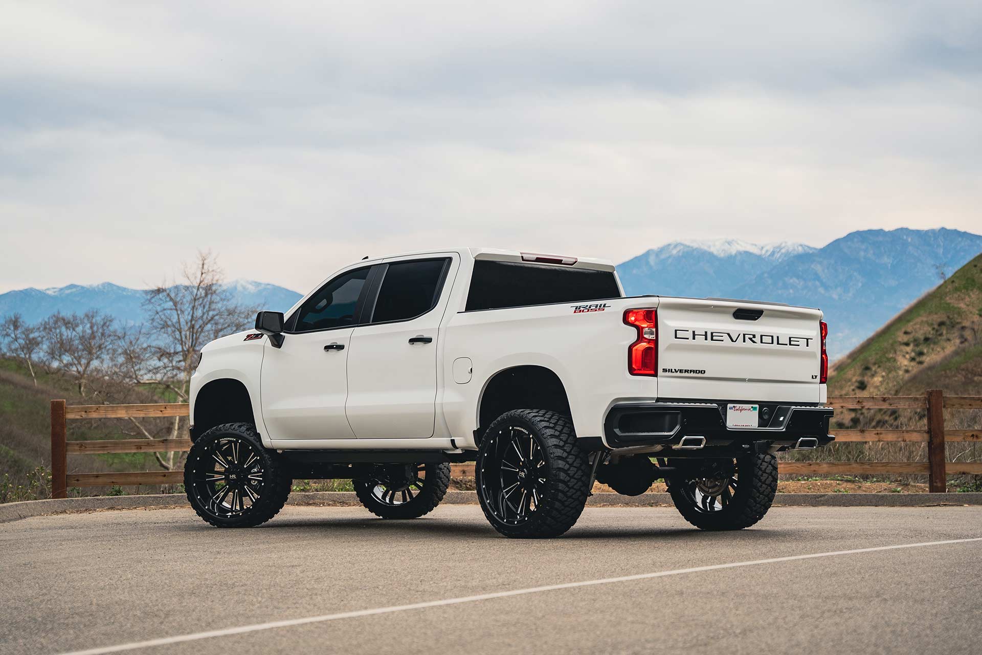 white chevy silverado trail boss with gloss black milled hardrock h503 off road wheels