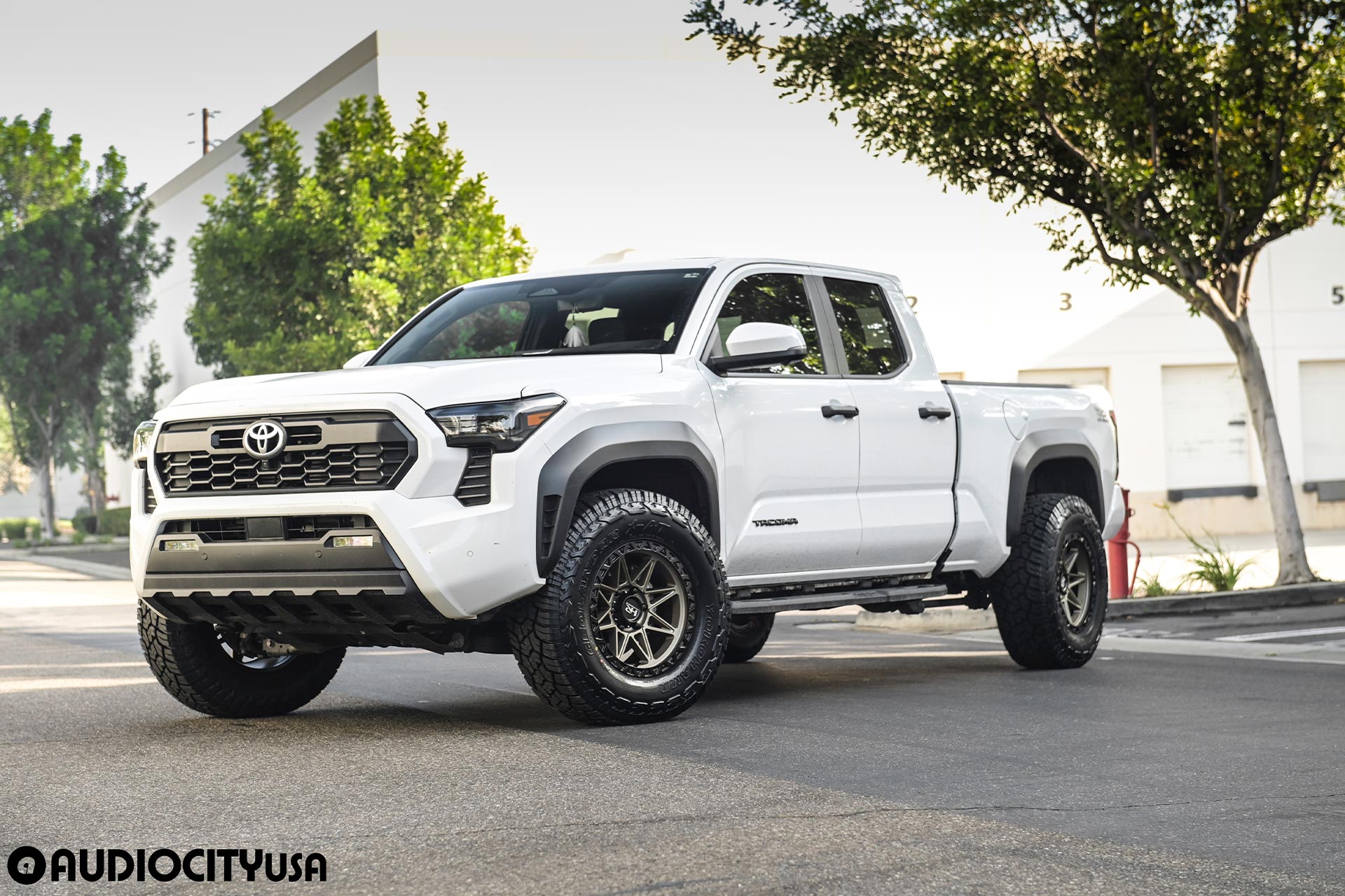 white 5th gen toyota tacoma trd off road with matte bronze hardrock offroad h109 wheels